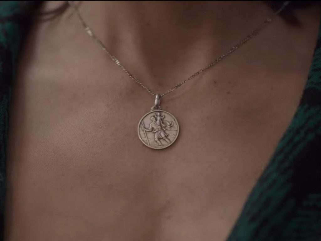 Hannah wearing a pendant gifted by Egon.